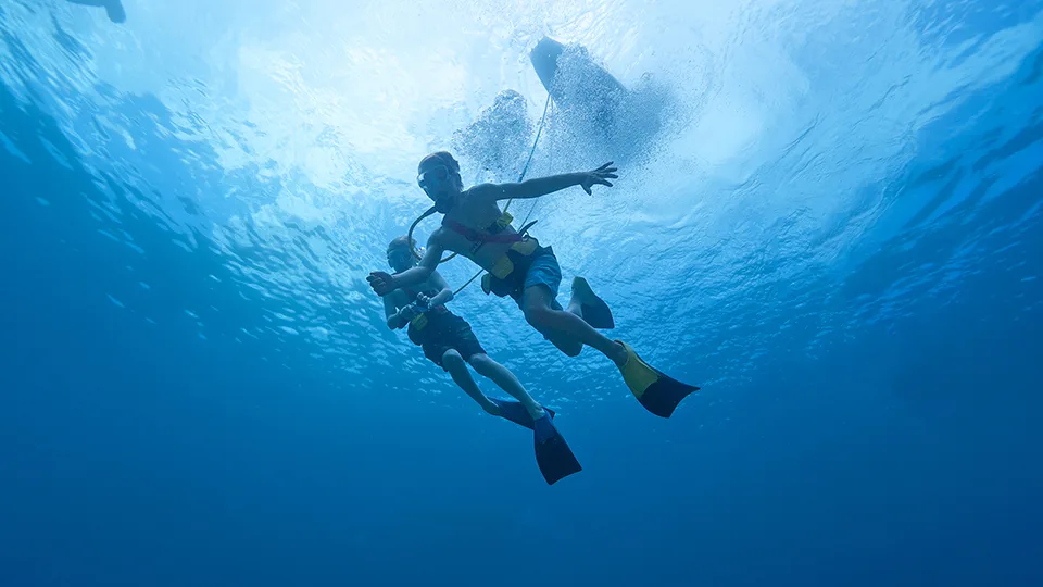 Two Boys SNUBA Diving Underwater