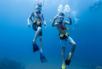 Two Boys SNUBA Diving Underwater on a Maui Snorkeling Cruise