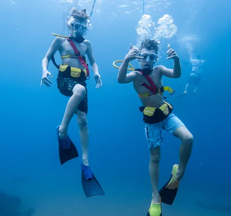 Two Boys SNUBA Diving Underwater on a Maui Snorkeling Cruise