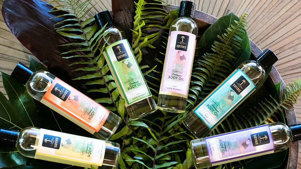 6 Bottles of Island Essence Oils on Leaves