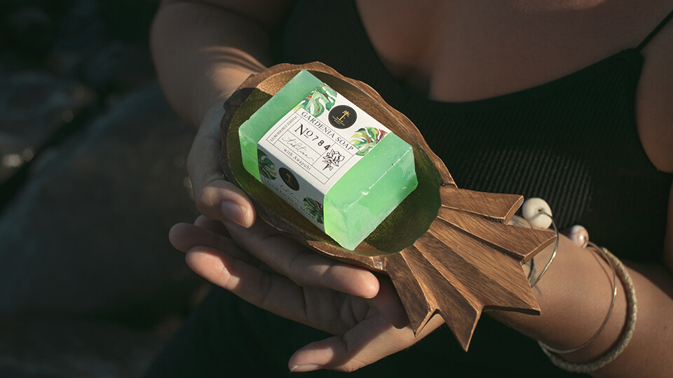 Woman Holding Pineapple Dish with Island Essence Gardenia Soap