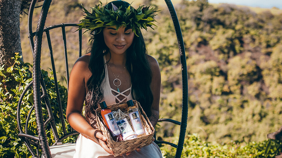 Woman Wearing Lei Po'o on Swing Holding Basket of Island Essence Products