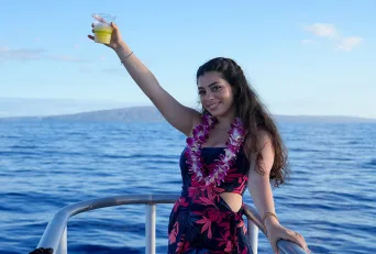 Guest on a Maui Sunset Cruise Holding Her Drink on Deck hawaii vacation guide maui