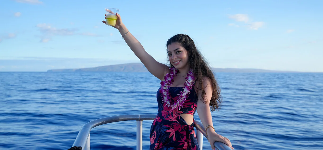 Guest on a Maui Sunset Cruise Holding Her Drink on Deck hawaii vacation guide maui