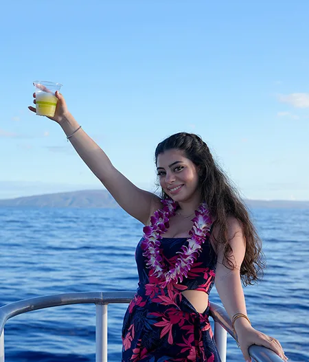 Guest on a Maui Sunset Cruise Holding Her Drink on Deck hawaii vacation guide maui