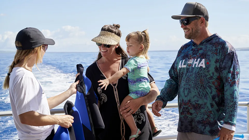 Crewmember Helping Family with Gear on Maui Snorkel Tour