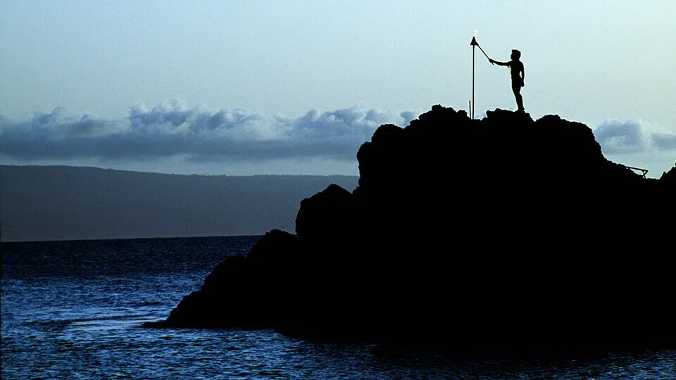 Ancient Hawaiian Voyager Lighting Torch on Rocky Cliffs