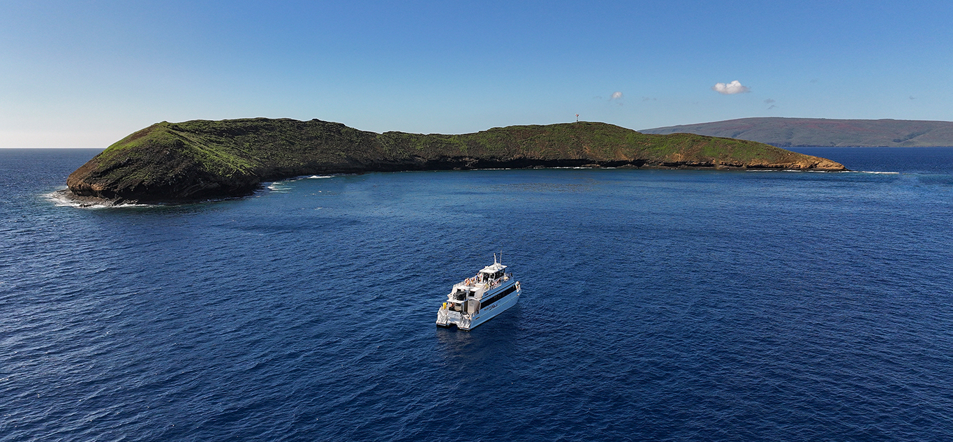 Snorkel tour boat near Molokini Crater in calm ocean conditions