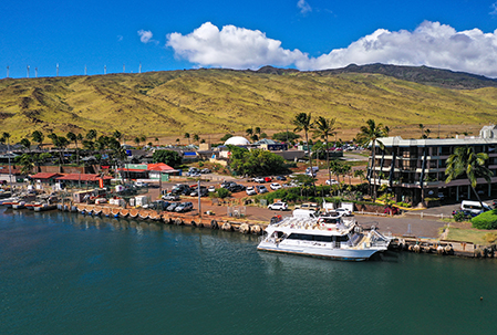 Aerial view of a Pride of Maui boat docked at Maalaea Harbor in the morning.