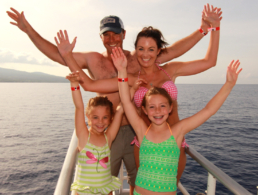 Family with two small kids on the bow of the Pride of Maui