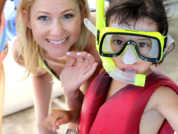 Woman her toddler in snorkel mask Maui snorkeling trip