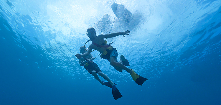 Two Boys SNUBA Diving Underwater on a Maui Snorkeling Tour